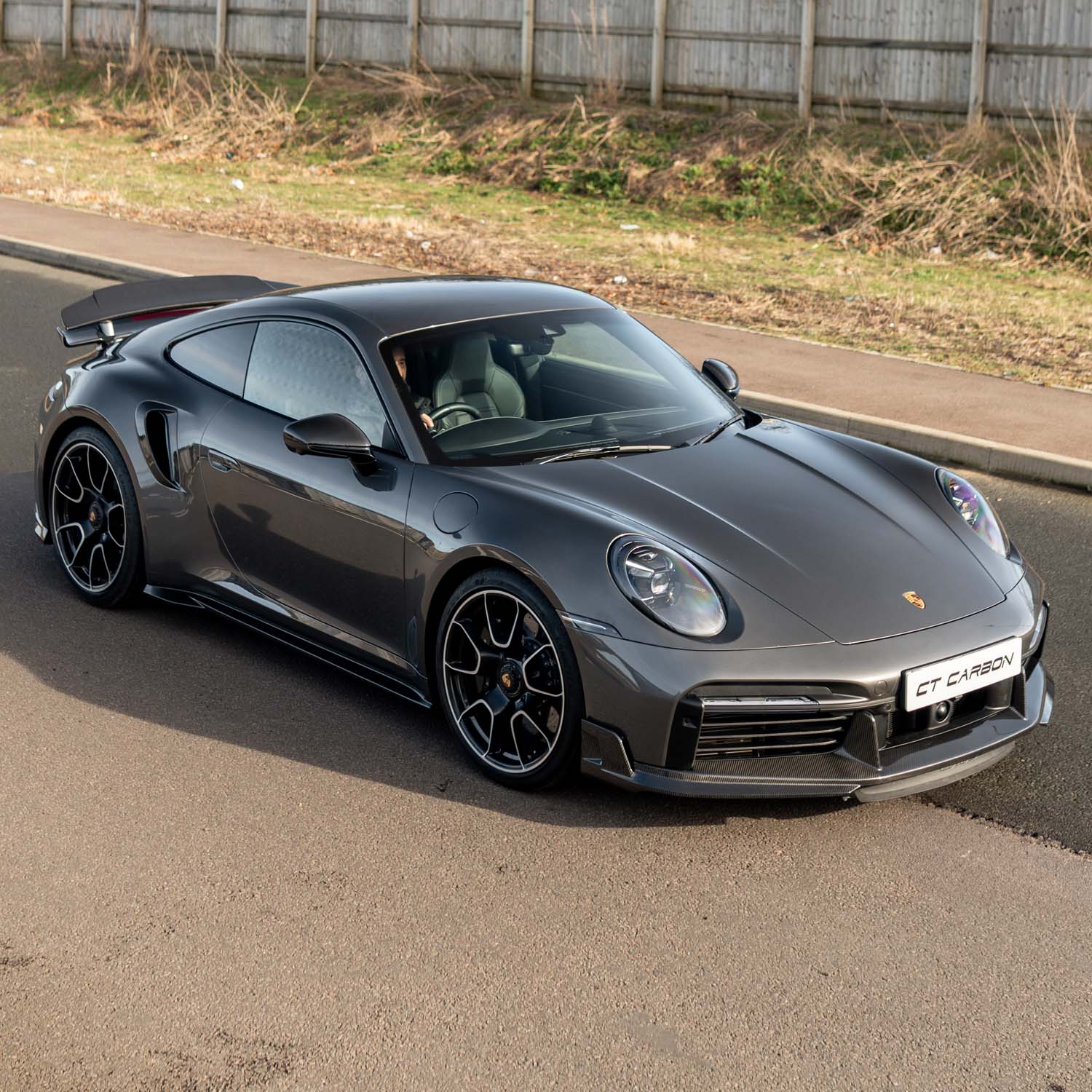 Agate grey Porsche 911 Turbo S with a subtle carbon front lip and side skirts, retaining its factory body shape